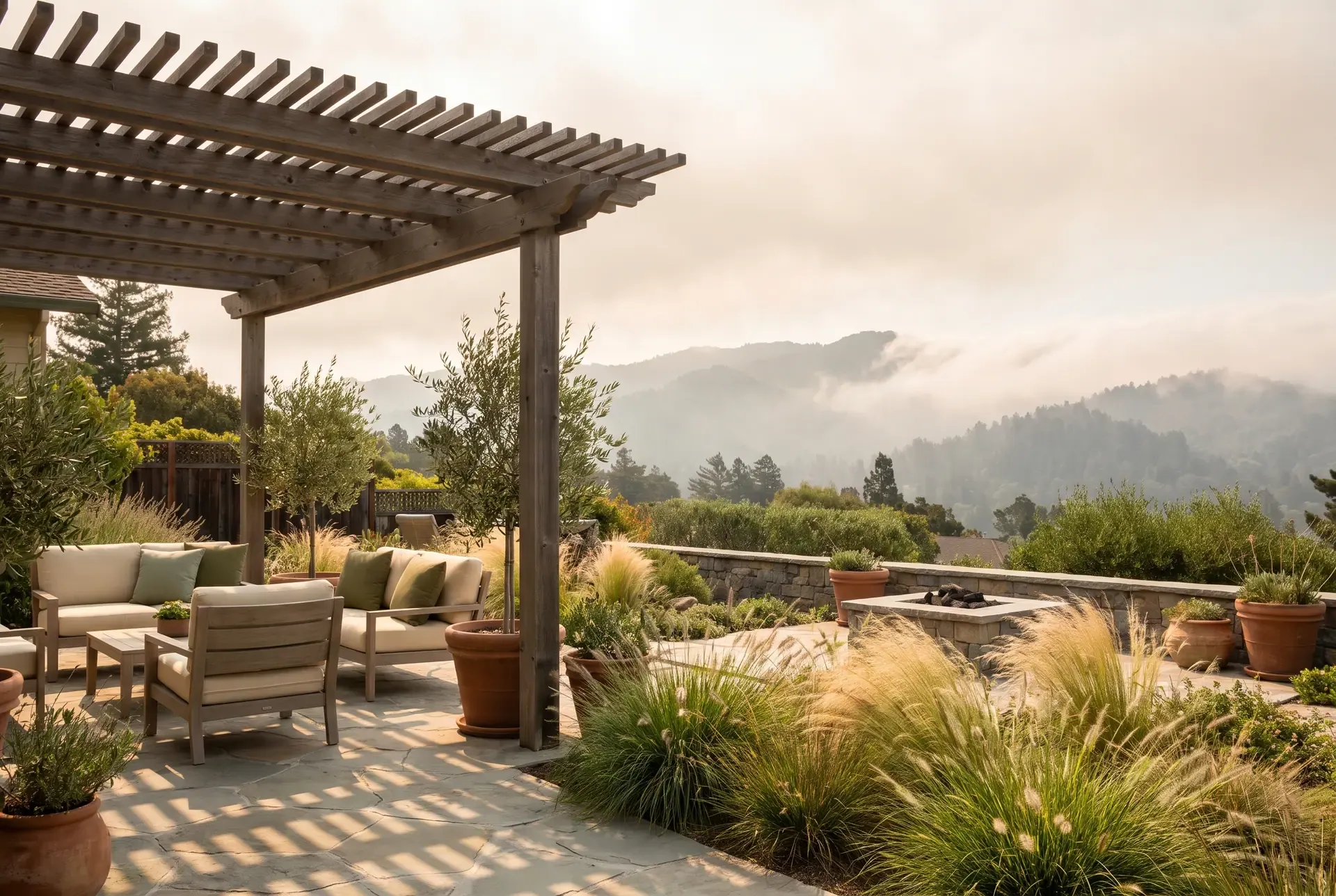 A Bay Area backyard illustration showing fog rolling over the coastal hills in the distance while a sunny patio in the foreground uses shade structures and wind-tolerant planting