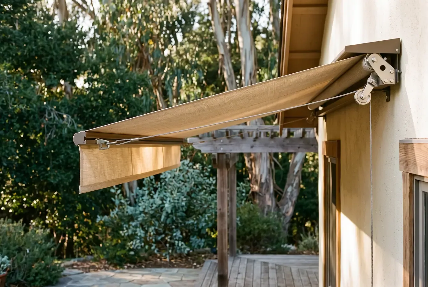 Close-up of retractable fabric canopy extended over a patio, showing the fabric texture and mounting hardware