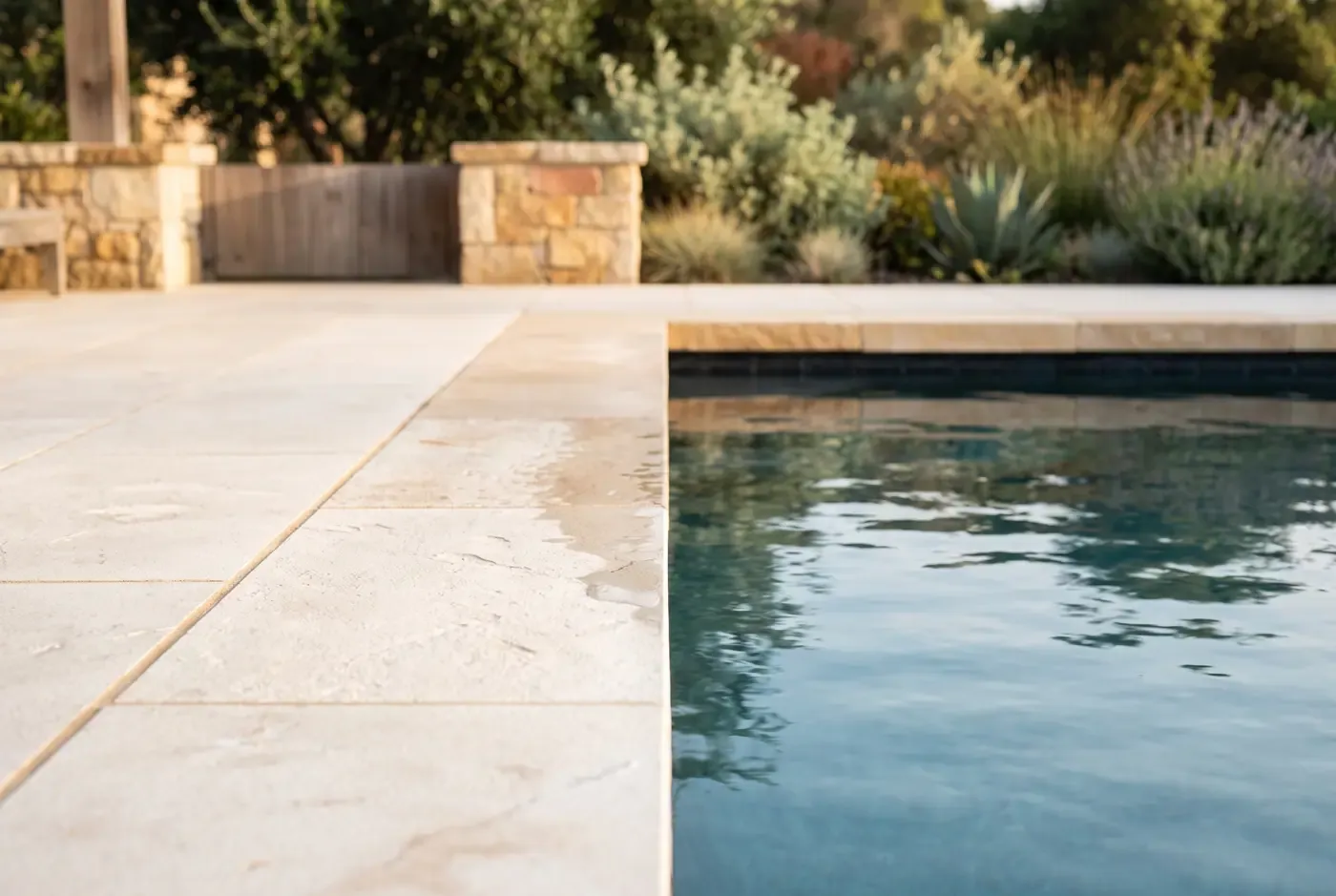 Light porcelain paver texture close-up next to a swimming pool